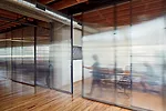 Polycarbonate sheets segment off conference rooms while still letting light through. 