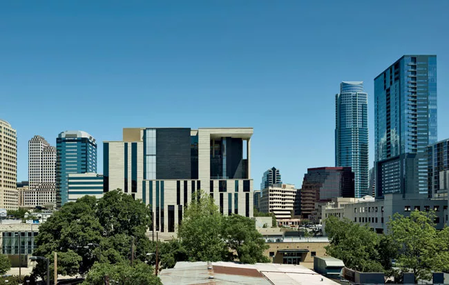 Scogin says he and Elam wanted the building to feel bigger than it is so it would have a presence in the burgeoning city. With that in mind, they used a rugged palette of limestone, stainless steel, a