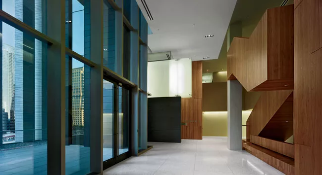 Internal stairs face outdoor terraces and connect double-height courtrooms with single-story spaces for jury deliberation and judges' offices.