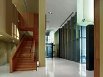 Internal stairs face outdoor terraces and connect double-height courtrooms with single-story spaces for jury deliberation and judges' offices.