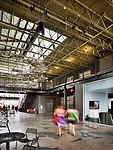 The Full Goods Warehouse, which once stored full bottles of beer, has found new life as a multi-use structure with restaurants, stores, offices, and live/work units. The architects cut skylit breezewa