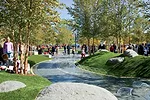 Children's park with raised geofoam mounds covered in artificial turf.
