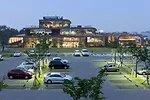 From the south, visitors arriving in the evening can see how the 98,850-square-foot building arranges functions into open work areas and communal spaces such as those for dining and presentations.