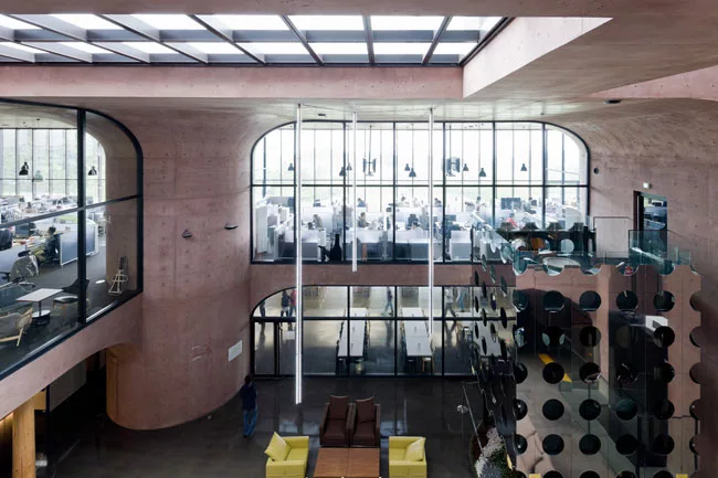 Office areas overlook a multistory atrium, one of two such spaces in the building. 