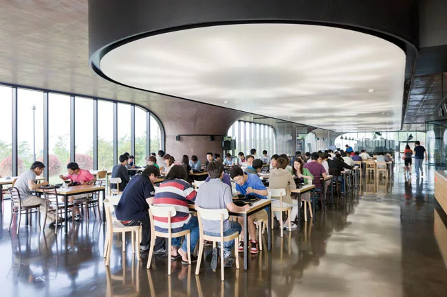 A cafeteria is just one of the shared facilities employees can enjoy, including a gym, a game room, lounges, and outdoor recreation areas for tennis and putting.