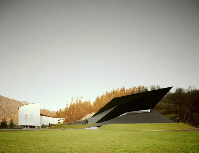 Anchored in a grassy slope, the new building holds an unlikely dialogue with the adjacent Passionsspielhaus, which has hosted Passion plays (acted out by the townspeople) once every six years since th