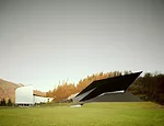 Anchored in a grassy slope, the new building holds an unlikely dialogue with the adjacent Passionsspielhaus, which has hosted Passion plays (acted out by the townspeople) once every six years since th