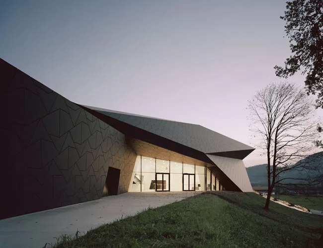 Charcoal-gray fiber cement panels clad the exterior and create a unique texture for the building’s sleek form.