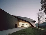 Charcoal-gray fiber cement panels clad the exterior and create a unique texture for the building’s sleek form.