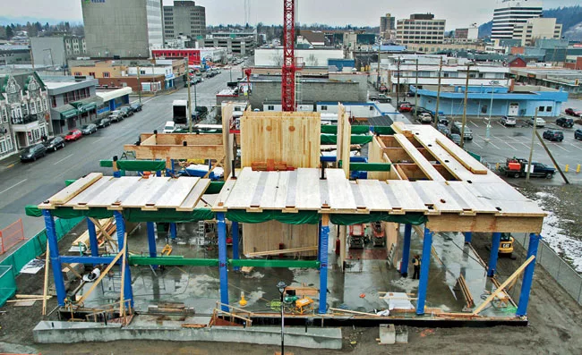 Its floors consist of overlapping CLT panels to create chases for building services.