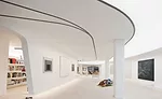In a New York City loft building, the architects designed the space where an art collector lives to have a flowing, light-filled backdrop for his art. LED lights above two layers of stretch translucen