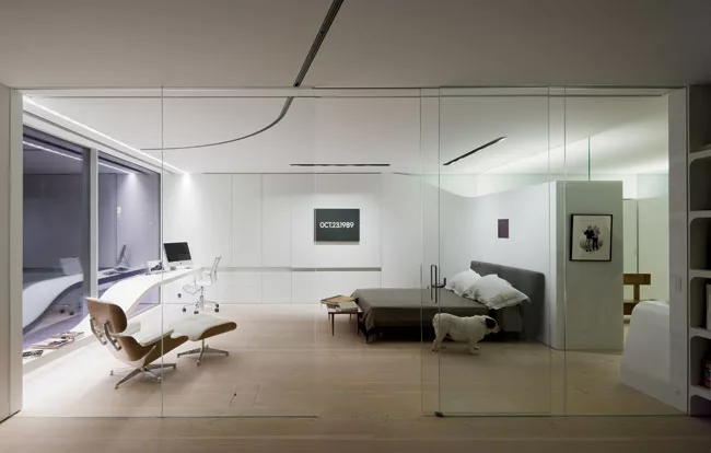 Leo, the bulldog, leaves his master's office and bedroom in the southwest corner, and saunters toward the walk-in-closet. The Eames chair (foreground), the solid-surface sculptural counter/table ' and