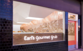 Unadorned plywood forms the backside of counter seating just inside Earl's storefront and serves as the backdrop for the eatery's neon sign.