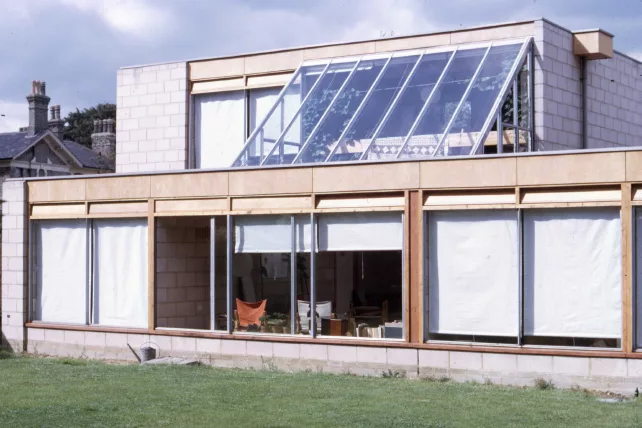 The building exterior as it was in the 1960s with exposed ply vents and fascias and exposed blockwork.