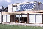 The building exterior as it was in the 1960s with exposed ply vents and fascias and exposed blockwork.