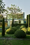 Since the angular glass house is located in a residential neighborhood, its owners decided to create a highly contoured garden adjoining it.  