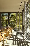 Slatted, Cambia wood screens shade all walls with views toward the lake in both buildings.