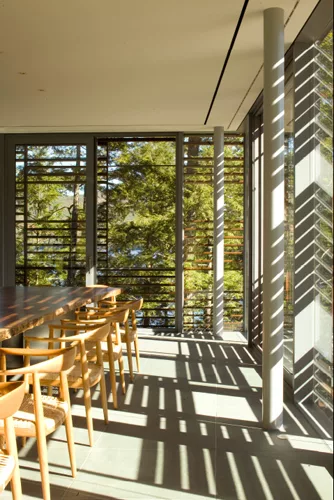Slatted, Cambia wood screens shade all walls with views toward the lake in both buildings.