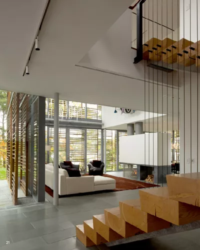 In the more private family house, flooring is locally quarried bluestone. Slatted, Cambia wood screens shade all walls with views toward the lake in both buildings.