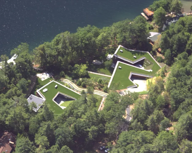 Grass roofs on the submerged family house serve to absorb summer heat and add insulation to reduce heating and cooling loads.