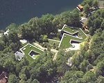 Grass roofs on the submerged family house serve to absorb summer heat and add insulation to reduce heating and cooling loads.