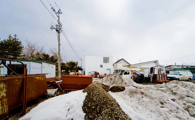 An industrial yard offers undesirable views on the house's south side.