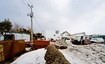 An industrial yard offers undesirable views on the house's south side.