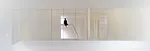 A staircase with treads of unpainted laurel wood leads from the ground level's concrete floor to the mezzanine levels above.