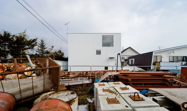An industrial yard offers undesirable views on the house's south side.