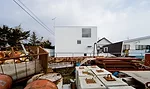 An industrial yard offers undesirable views on the house's south side.