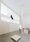 Catwalks and platforms accessible by ladders make the voids on the north and south sides of the house a sort of false exterior'bringing the focus to the central living zone where an 18.5-foot-high col