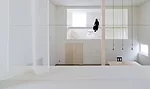 Catwalks and platforms accessible by ladders make the voids on the north and south sides of the house a sort of false exterior'bringing the focus to the central living zone where an 18.5-foot-high col
