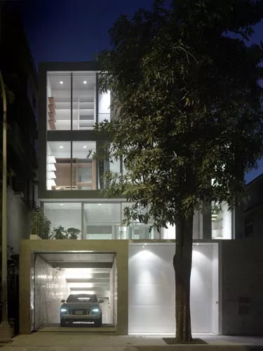 An unassuming street elevation disguises a courtyard within and an entrance to the garage underneath.