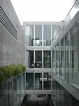 Parallel to the garden is a series of niches for displaying art, and large steps leading to a sitting area in the front.