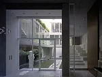 Parallel to the garden is a series of niches for displaying art, and large steps leading to a sitting area in the front.