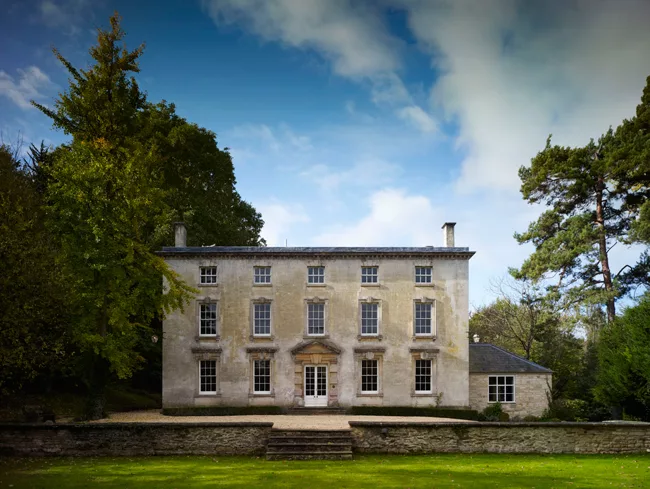 The blocky Georgian mansion, built 266 years ago, and an outbuilding are connected to a remarkable garden by a modern glass-and-concrete pavilion at the rear of the house.