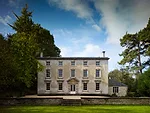 The blocky Georgian mansion, built 266 years ago, and an outbuilding are connected to a remarkable garden by a modern glass-and-concrete pavilion at the rear of the house.