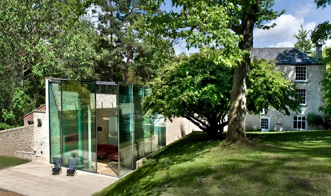The fascia of the concrete roof is clad with soft gray aluminum to keep the color palette of the structure consistent when observed from the house's upper windows.  The pavilion's corner glass walls f