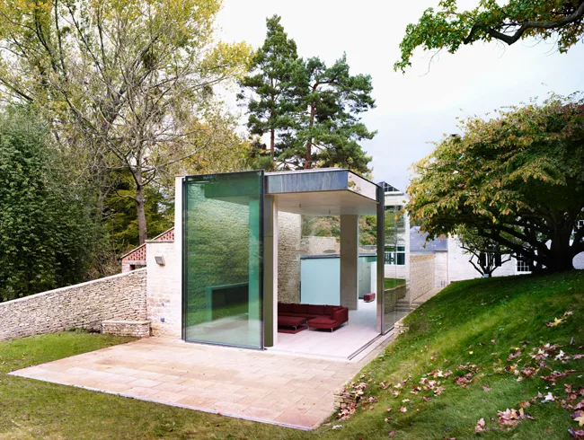 The fascia of the concrete roof is clad with soft gray aluminum to keep the color palette of the structure consistent when observed from the house's upper windows.  The pavilion's corner glass walls f