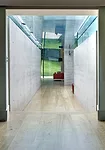 The fascia of the concrete roof is clad with soft gray aluminum to keep the color palette of the structure consistent when observed from the house's upper windows.  The pavilion's corner glass walls f