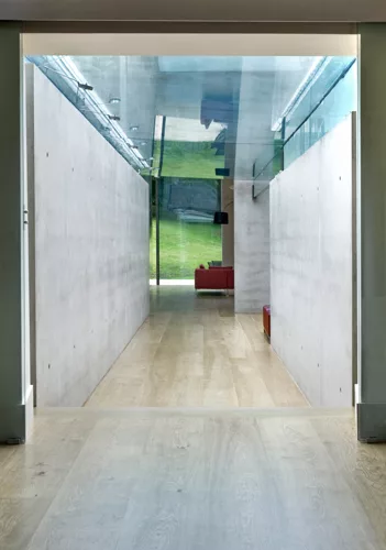 The fascia of the concrete roof is clad with soft gray aluminum to keep the color palette of the structure consistent when observed from the house's upper windows.  The pavilion's corner glass walls f