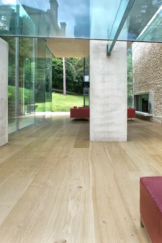 At the rear of the house, concrete decks and sectional cuts allow natural light to permeate the sitting area and an elevated dining space.