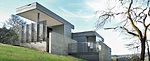 Concrete retaining walls nestle the house in a hill. The region is subject to landslides so the architects buried utilities and improved grading. 