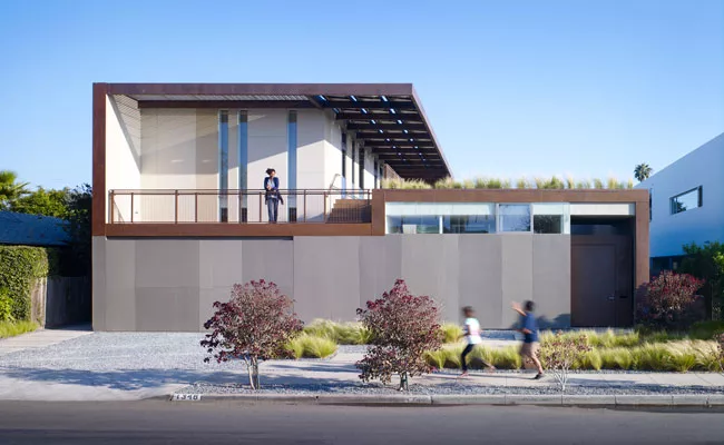The Yin-Yang House, named by the clients, unifies indoor and outdoor spaces into a whole. It appears solid from its street-facing facade, clad in cement board, but gives way to courtyards.  