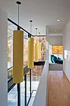 Inside, the architect kept the palette muted to reflect light: white-oak floors on the second story and terrazzo-covered concrete slabs on the first.
