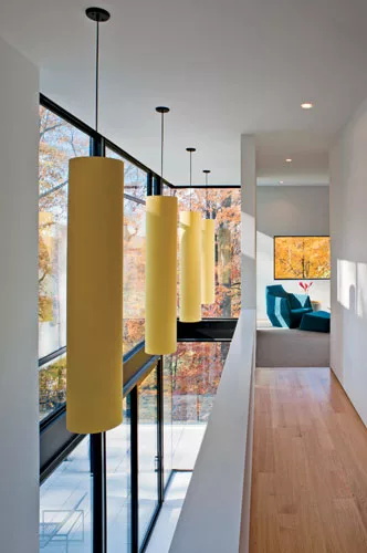 Inside, the architect kept the palette muted to reflect light: white-oak floors on the second story and terrazzo-covered concrete slabs on the first.