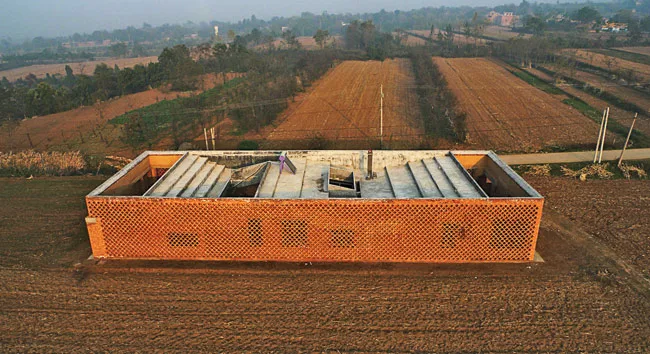 An angled concrete roof collects and stores rainwater and provides a place to dry food.