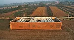 An angled concrete roof collects and stores rainwater and provides a place to dry food.