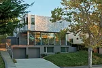 The architect set the stucco ground level into the hillside and pushed the house back from the street.