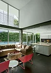The basalt floor is carried inside to the kitchen and living spaces on the second floor, where it complements bright furnishings.